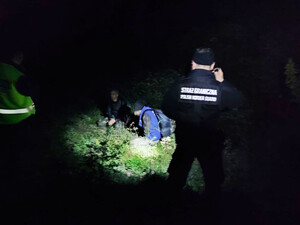 Funkcjonariusz SG podczas patrolu w Macedonii, w tle zatrzymani migranci. Funkcjonariusz SG podczas patrolu w Macedonii, w tle zatrzymani migranci.